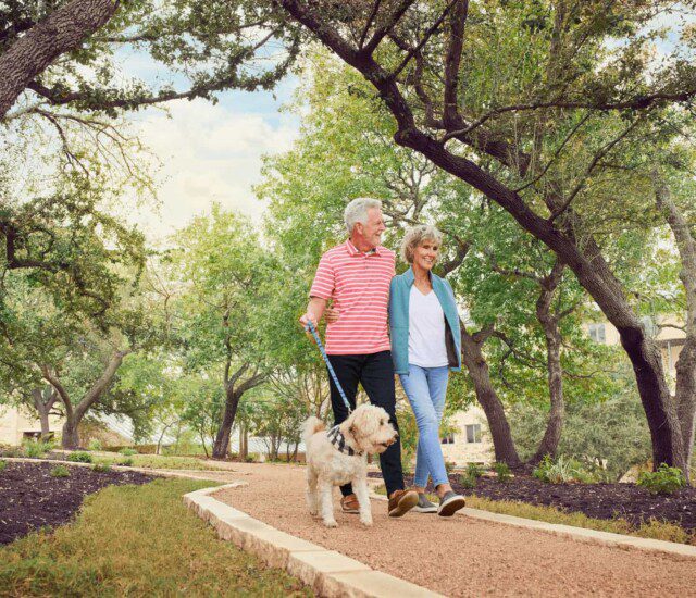 ouple walking a dog outside