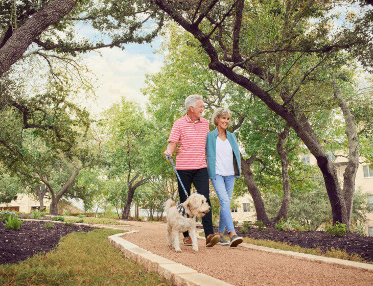 ouple walking a dog outside